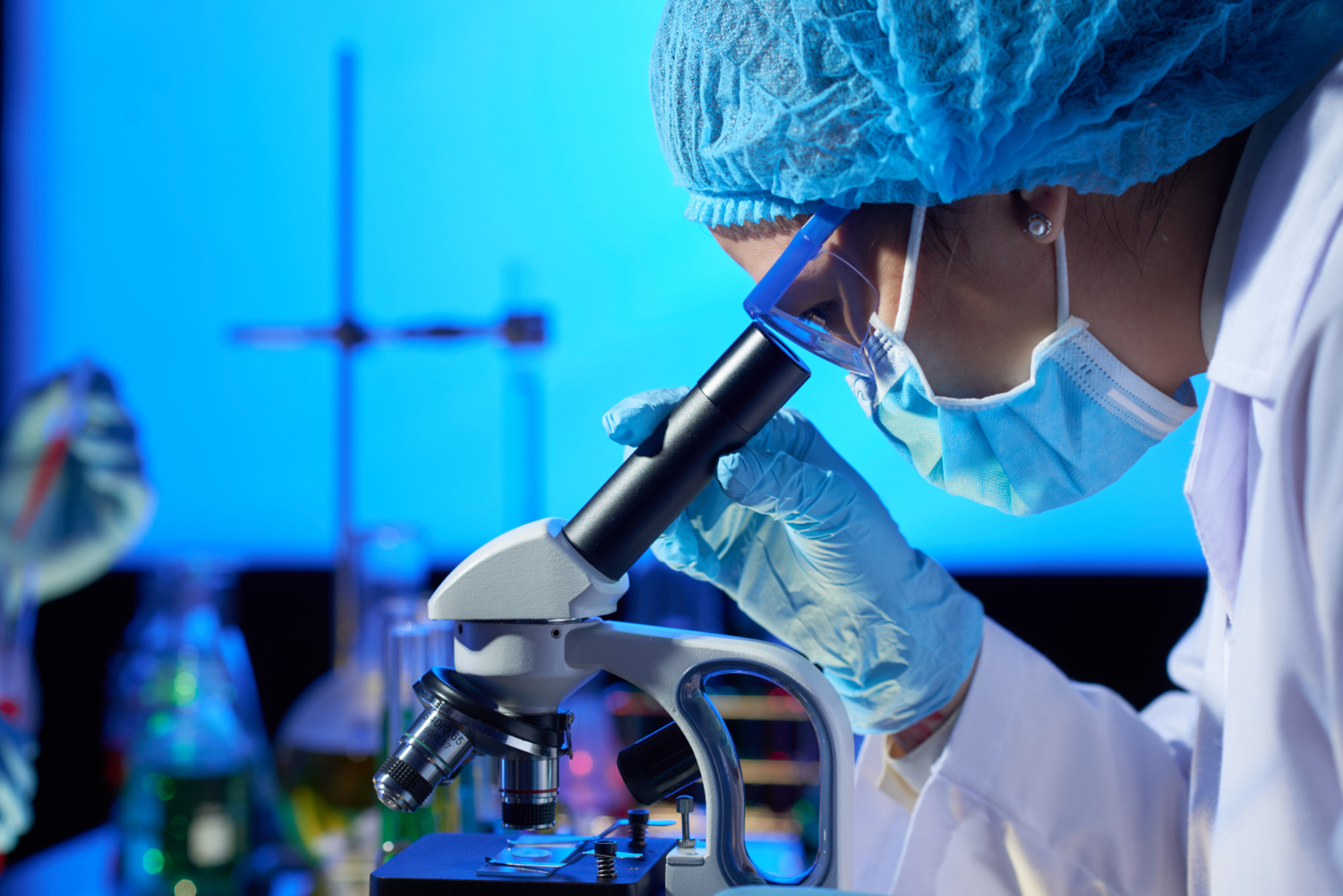 Scientist examining a sample under a microscope